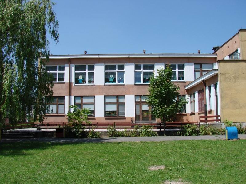 Budynek przedszkola, taras i trawa przed budynkiem